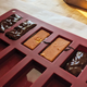 Photo of the candy bar filling in a silicon mold. This photo shows the individual steps: chocolate lined bottom, then placed filling, then topped with more chocolate to set.